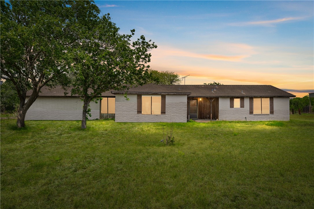 5469 Sunset Trail Robstown, TX 78380 - Photo 1 of 37 a view of a yard in front of a house with a large tree