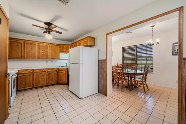 a kitchen with a refrigerator a microwave and dining table