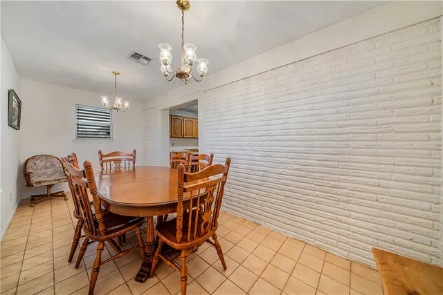 a dining room with furniture and chandelier