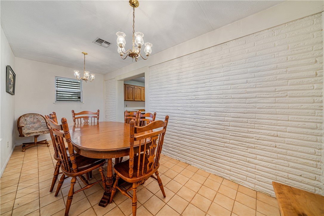 5469 Sunset Trail Robstown, TX 78380 - Photo 16 of 37 a dining room with furniture and chandelier