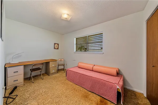 a bedroom with furniture and a window