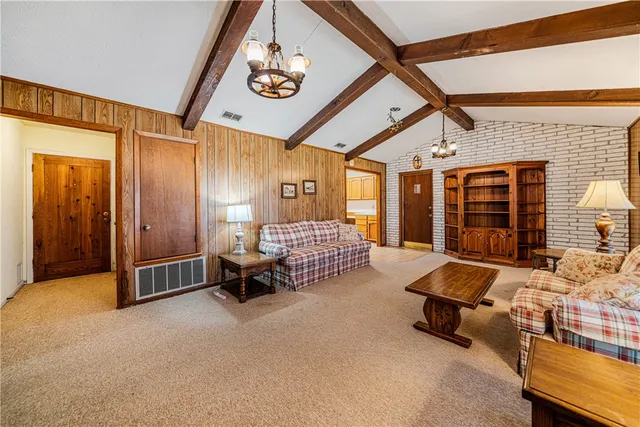a spacious bedroom with a bed couch and a window