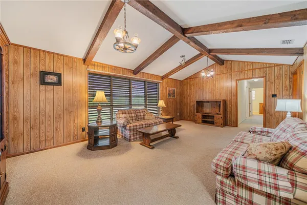 a bedroom with furniture and a large window