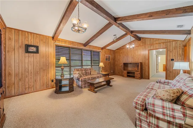 a bedroom with furniture and a large window