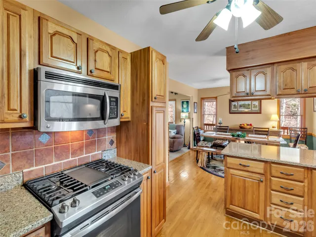a kitchen with a stove a sink and a microwave