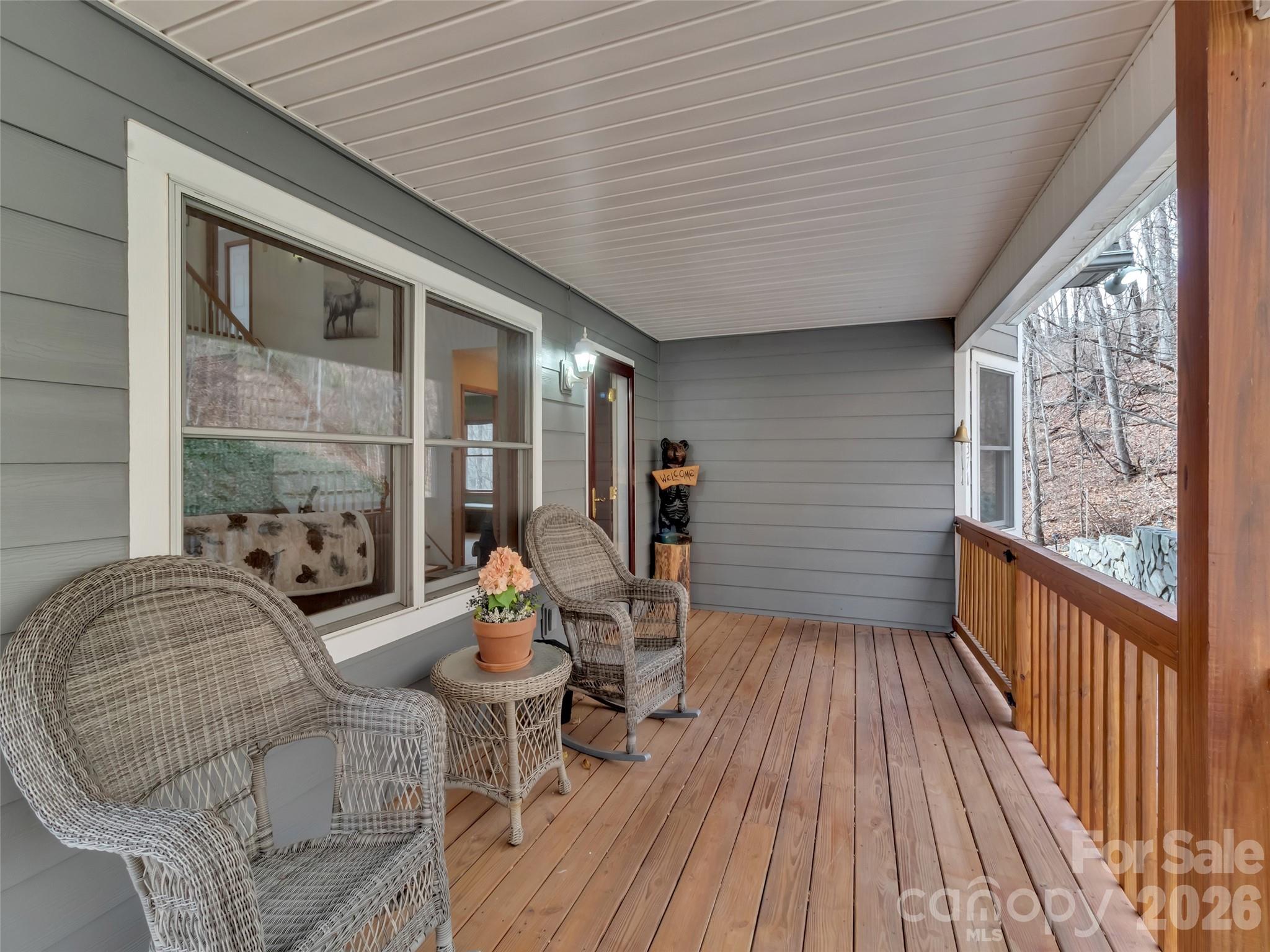 371 Falcon Ridge Drive Waynesville, NC 28786 - Photo 21 of 48 a view of a balcony with chairs and wooden floor