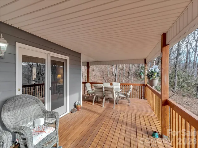 a balcony with furniture and wooden floor