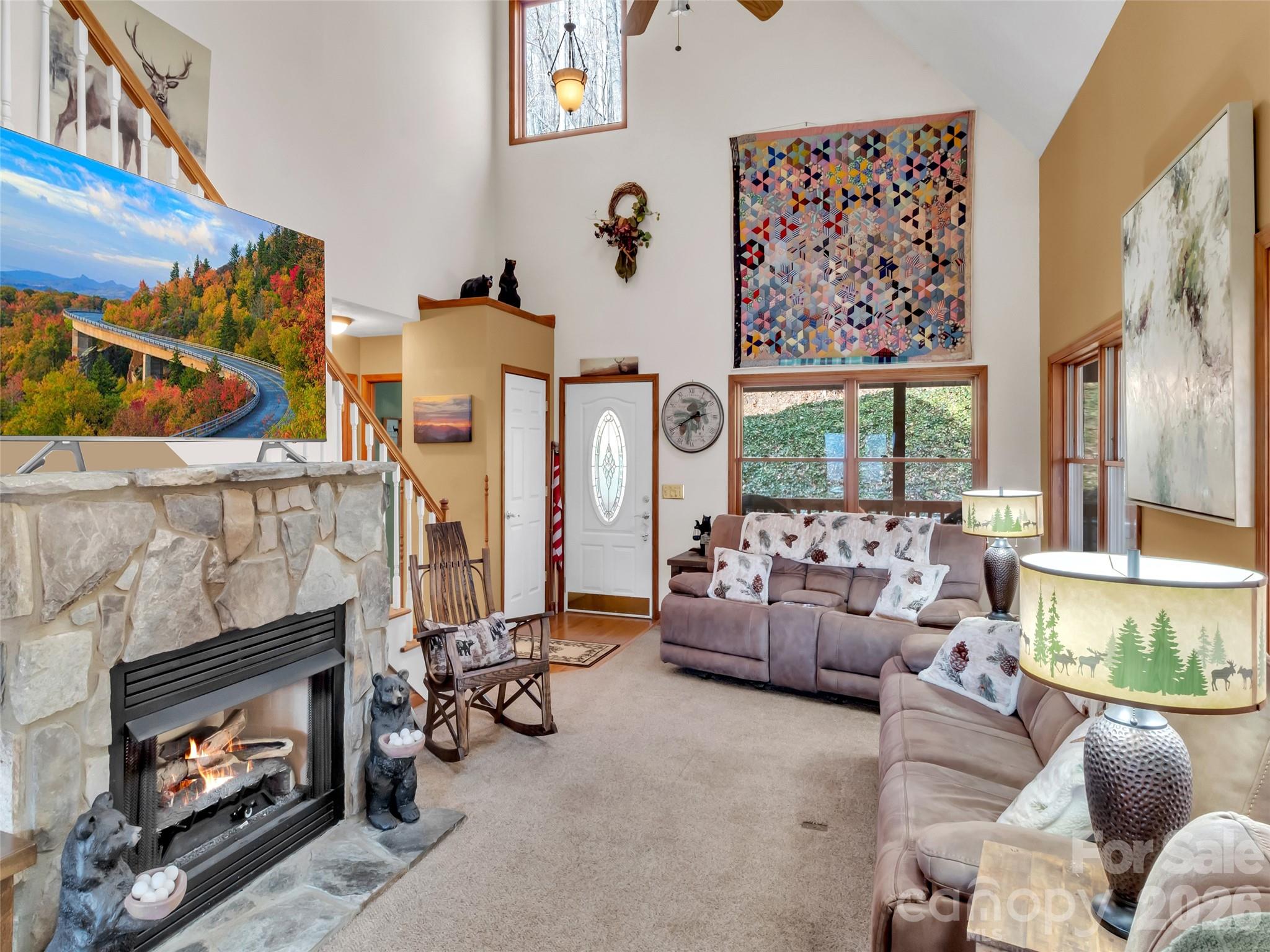 371 Falcon Ridge Drive Waynesville, NC 28786 - Photo 5 of 48 a living room with furniture a fireplace and a large window