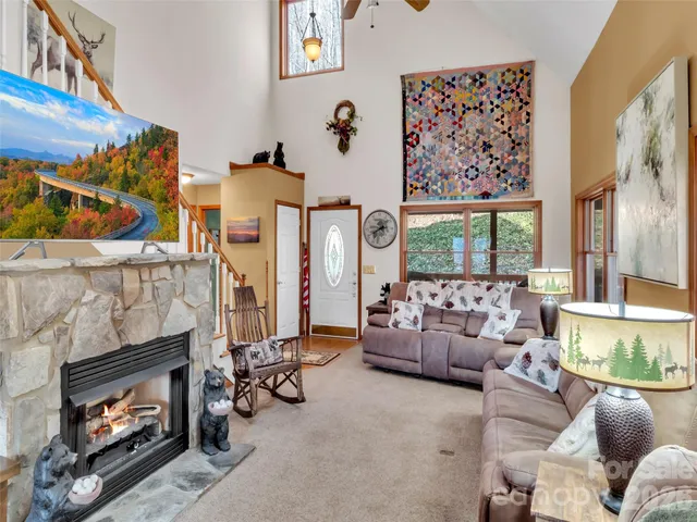 a living room with furniture a fireplace and a large window