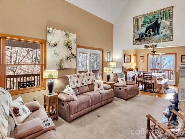 a living room with furniture large window and flat screen tv