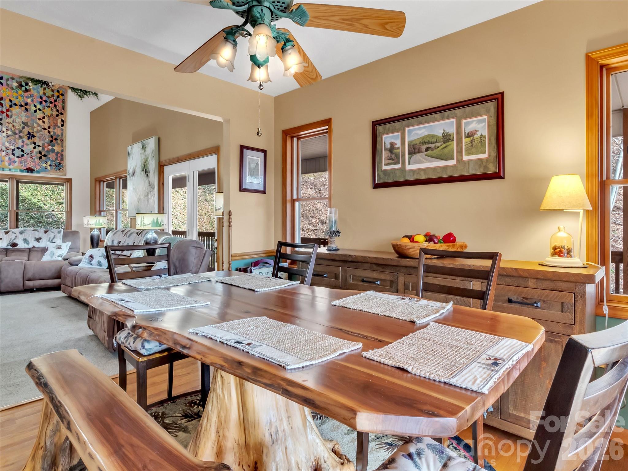 371 Falcon Ridge Drive Waynesville, NC 28786 - Photo 9 of 48 a view of a dining room with furniture a chandelier and wooden floor