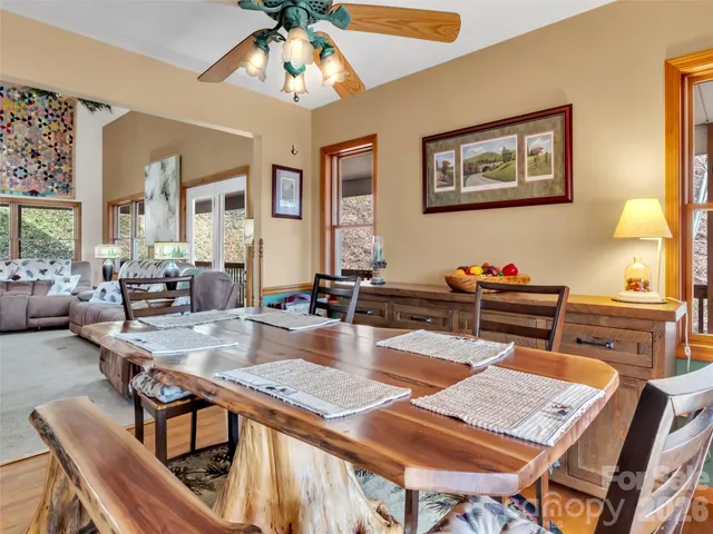 a view of a dining room with furniture a chandelier and wooden floor