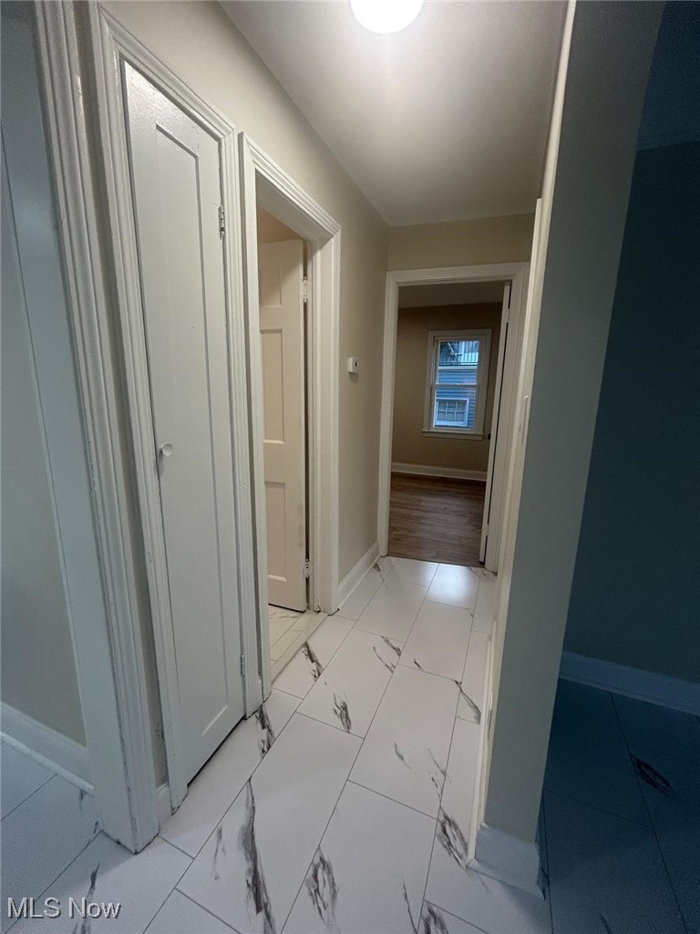 15410 Turney Road Maple Heights, OH 44137 - Photo 23 of 46 Corridor with baseboards and light marble finish floors