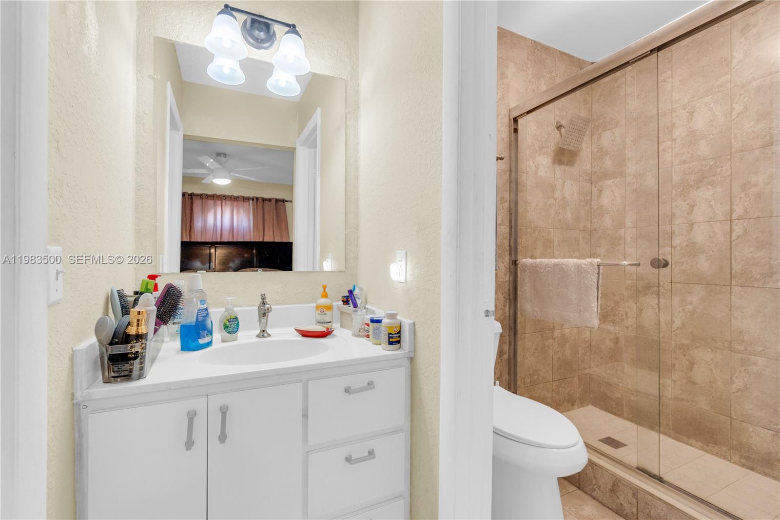 12691 Southwest 190th Street Miami, FL 33177 - Photo 12 of 46 a bathroom with a sink vanity mirror and toilet