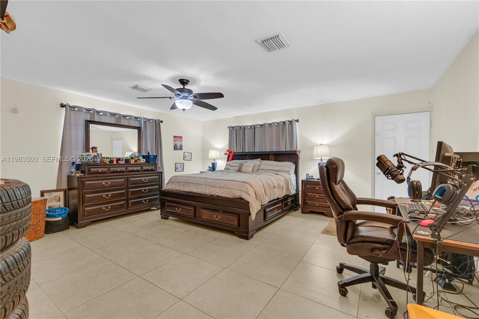 12691 Southwest 190th Street Miami, FL 33177 - Photo 14 of 46 a bedroom with a bed and furniture