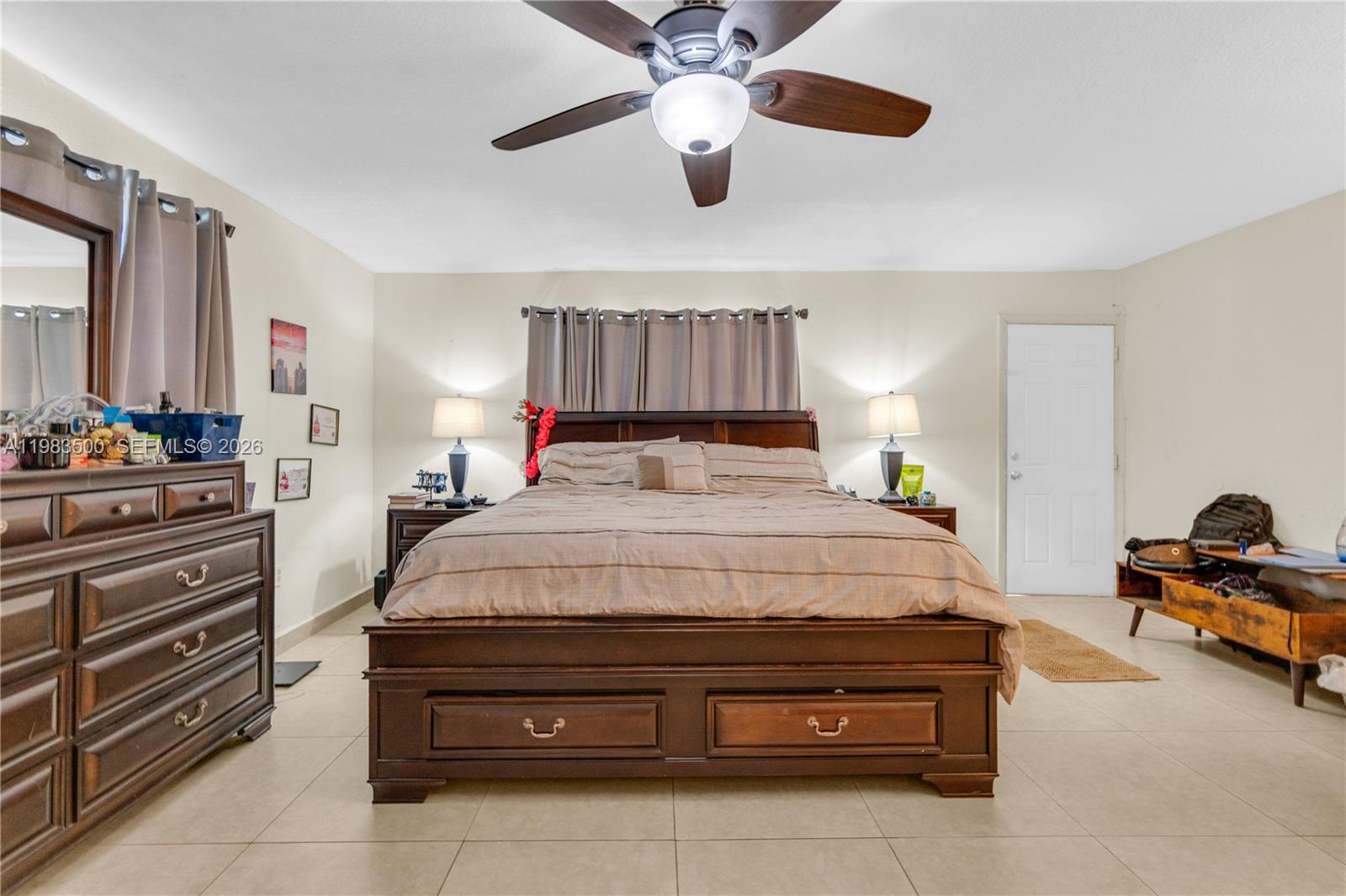 12691 Southwest 190th Street Miami, FL 33177 - Photo 15 of 46 a bedroom with a bed and a chandelier