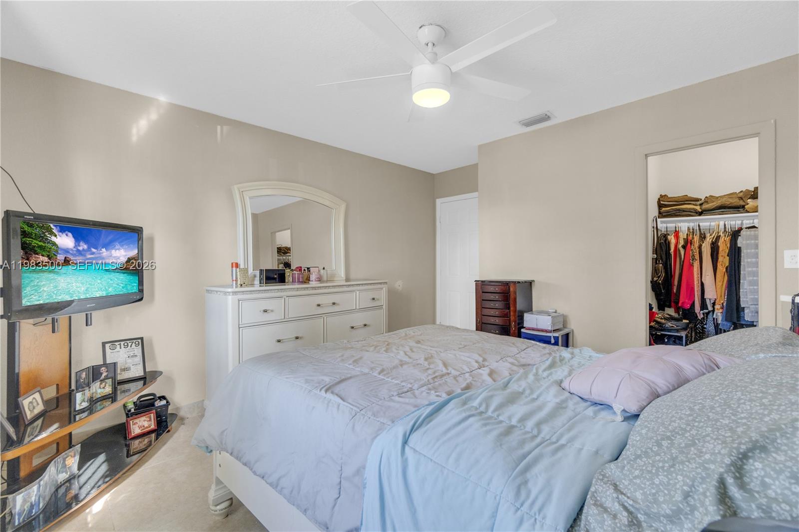 12691 Southwest 190th Street Miami, FL 33177 - Photo 17 of 46 a bedroom with a bed and a flat screen tv