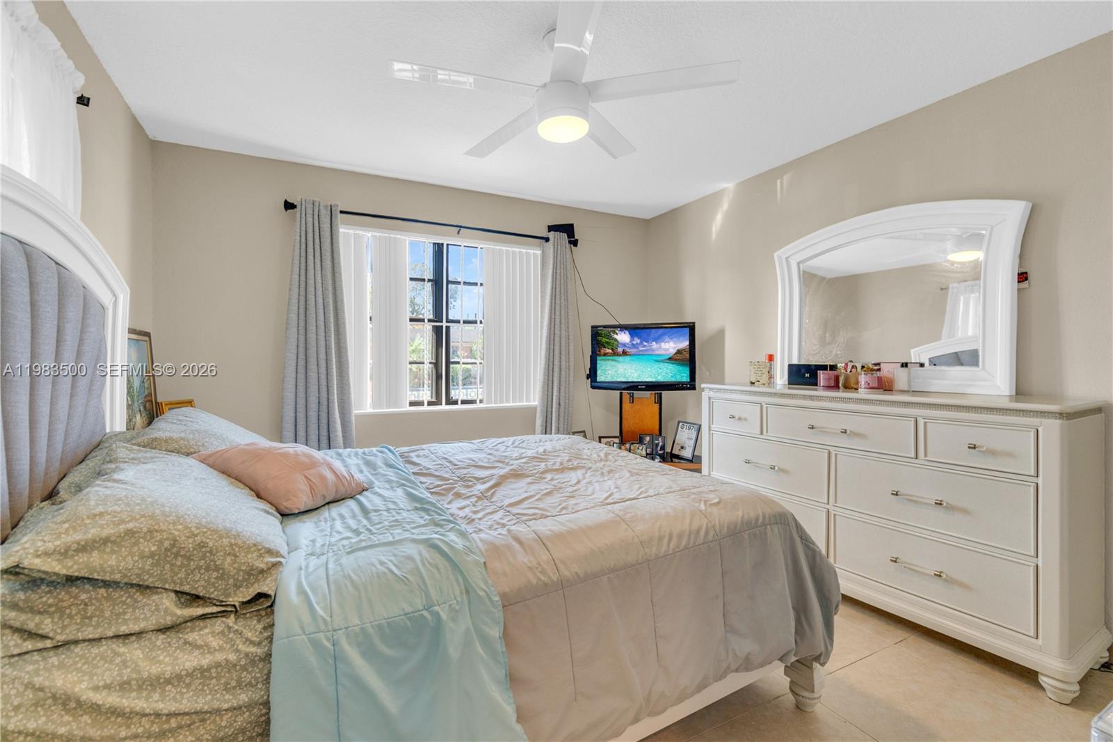 12691 Southwest 190th Street Miami, FL 33177 - Photo 18 of 46 a bedroom with a bed and a dresser