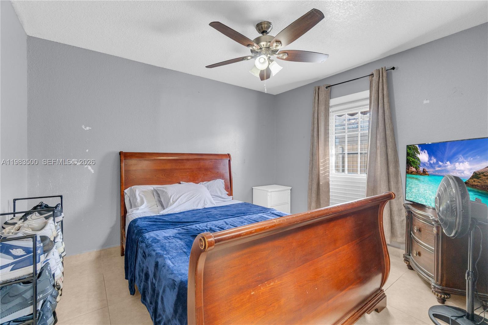 12691 Southwest 190th Street Miami, FL 33177 - Photo 19 of 46 a bedroom with a bed and a flat screen tv