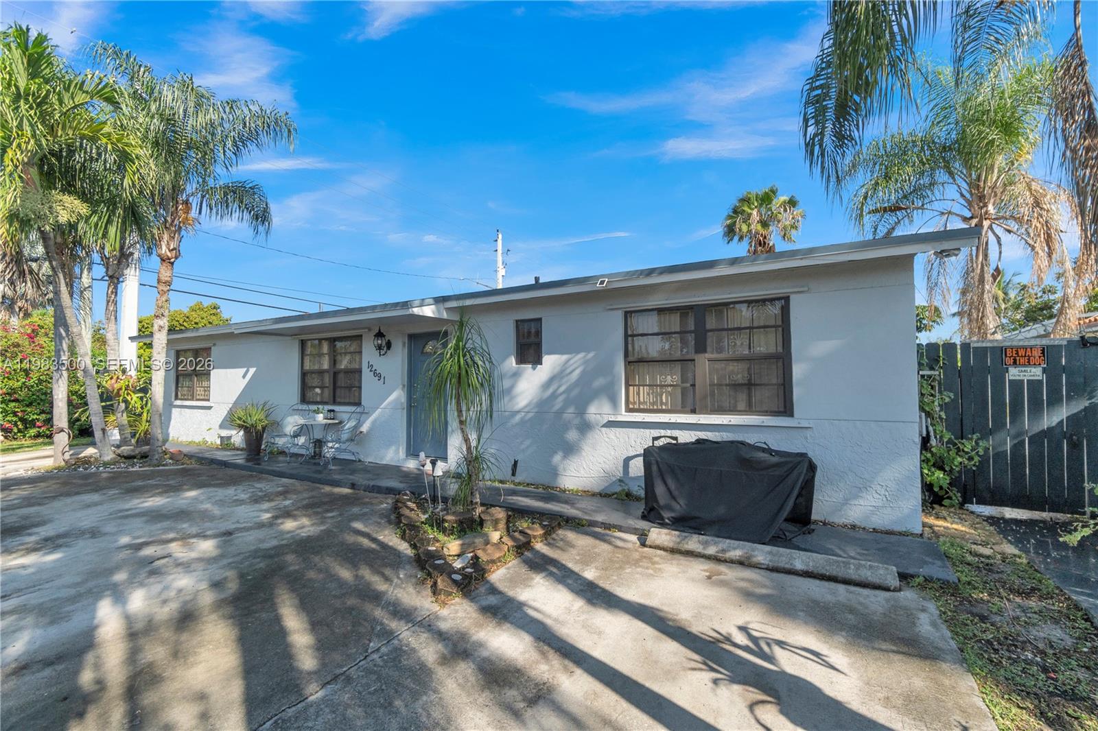 12691 Southwest 190th Street Miami, FL 33177 - Photo 2 of 46 a front view of a house with garden