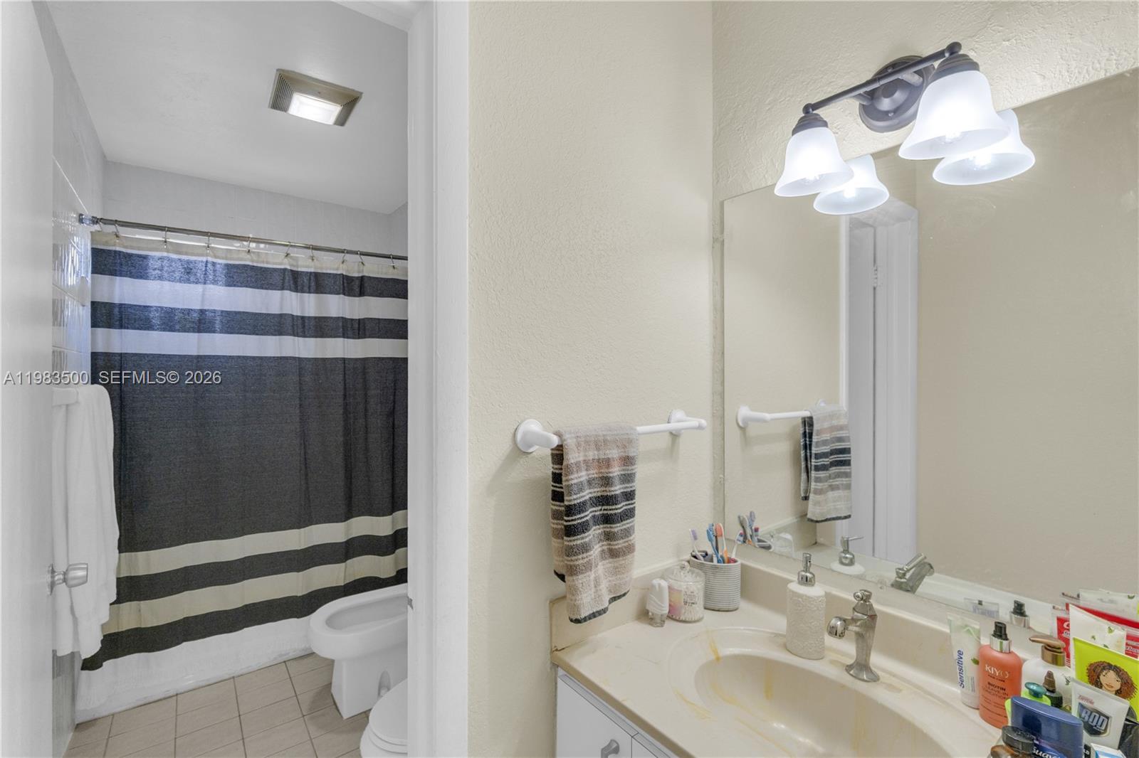 12691 Southwest 190th Street Miami, FL 33177 - Photo 21 of 46 a bathroom with a sink a mirror and a shower
