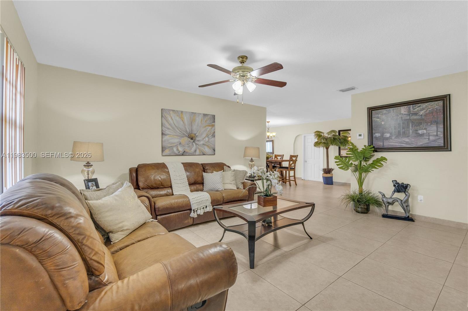12691 Southwest 190th Street Miami, FL 33177 - Photo 23 of 46 a living room with furniture and a chandelier