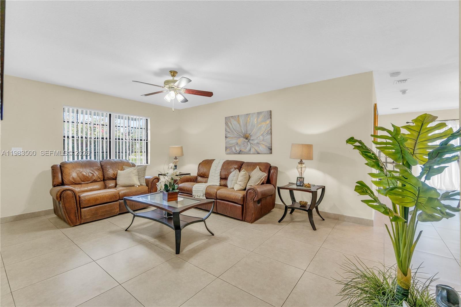 12691 Southwest 190th Street Miami, FL 33177 - Photo 24 of 46 a living room with furniture a chandelier and a potted plant