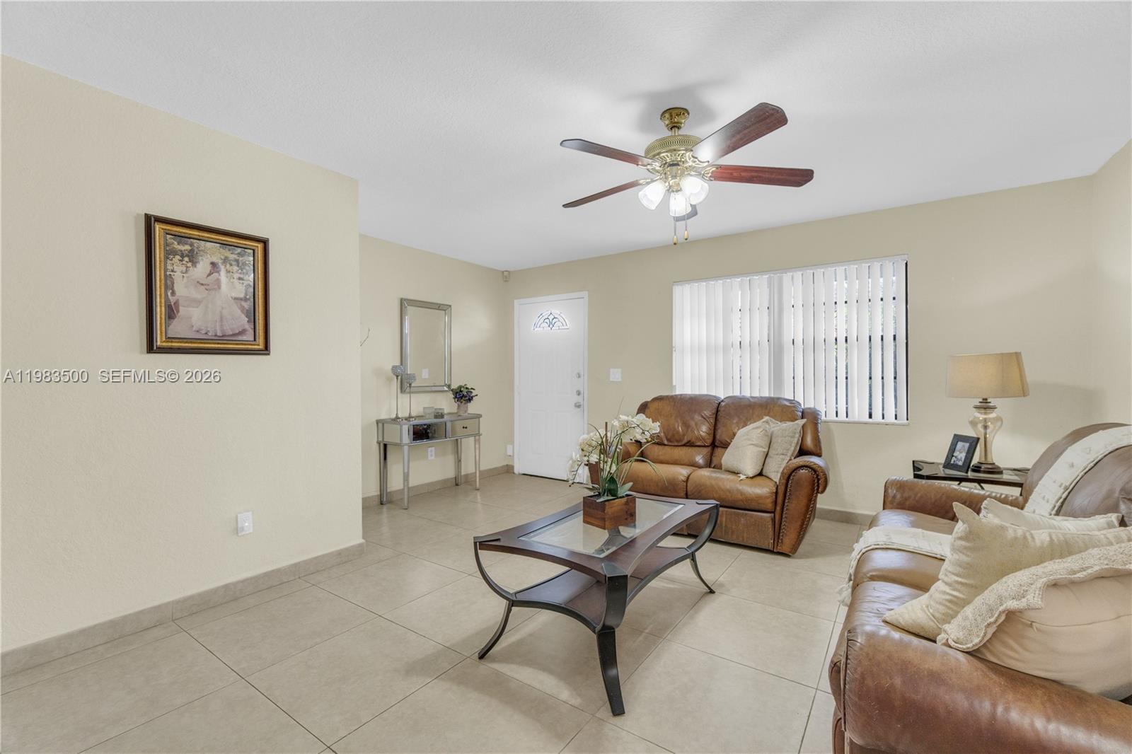 12691 Southwest 190th Street Miami, FL 33177 - Photo 25 of 46 a living room with furniture a ceiling fan and a window