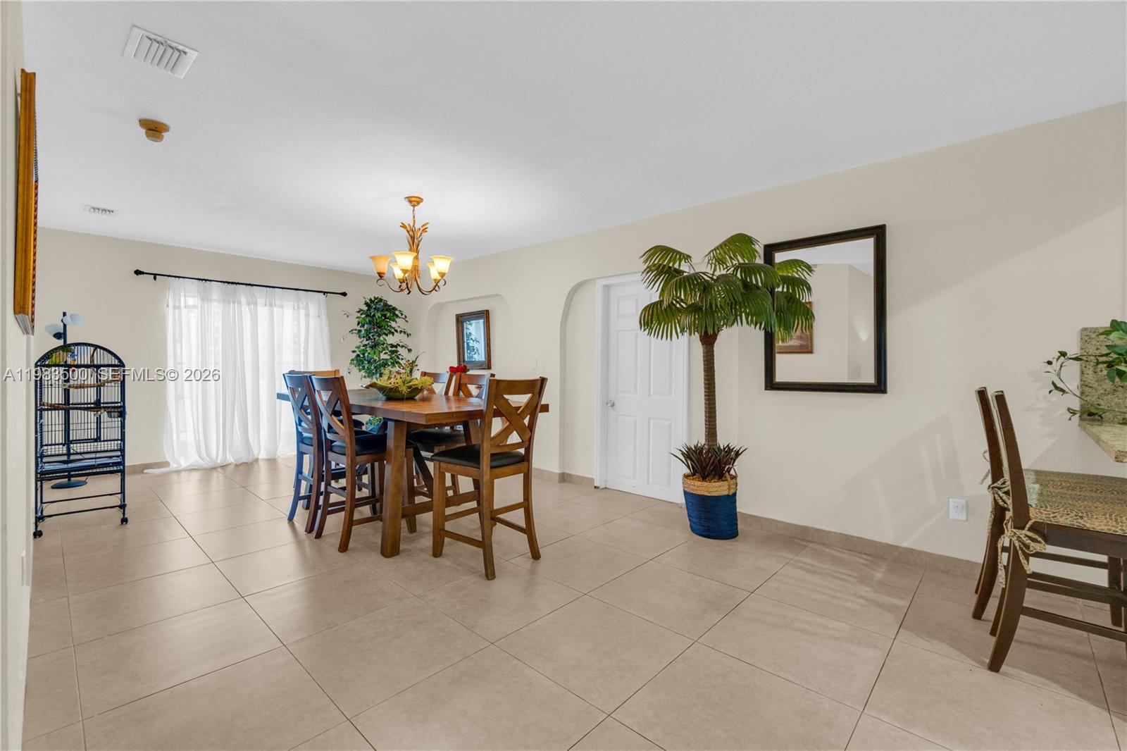 12691 Southwest 190th Street Miami, FL 33177 - Photo 27 of 46 a dining room filled with furniture and a potted plant