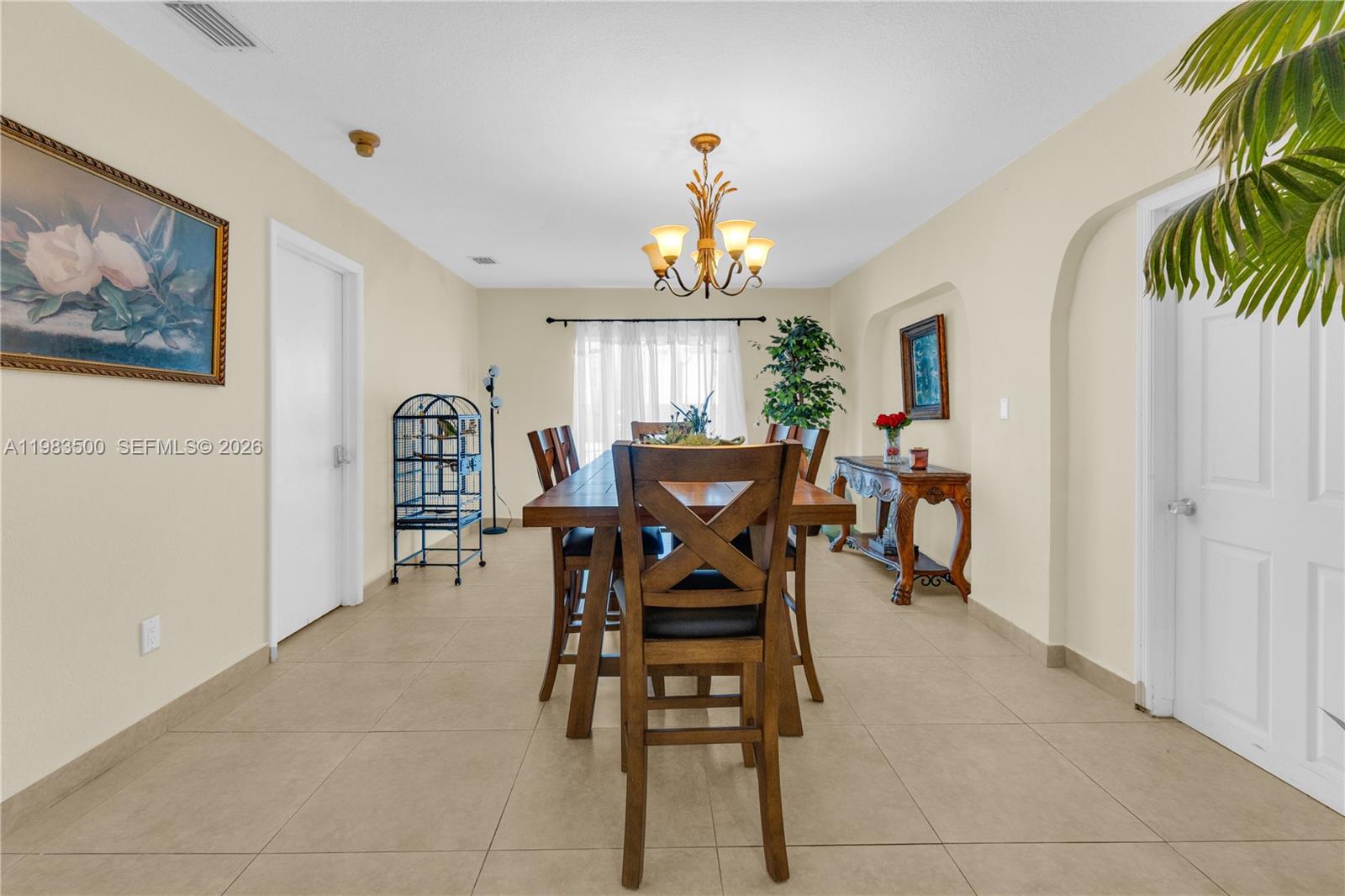 12691 Southwest 190th Street Miami, FL 33177 - Photo 28 of 46 a view of a dining room with furniture and a chandelier