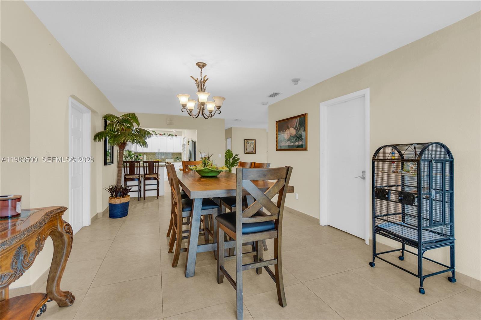 12691 Southwest 190th Street Miami, FL 33177 - Photo 29 of 46 a view of a dining room with furniture and chandelier
