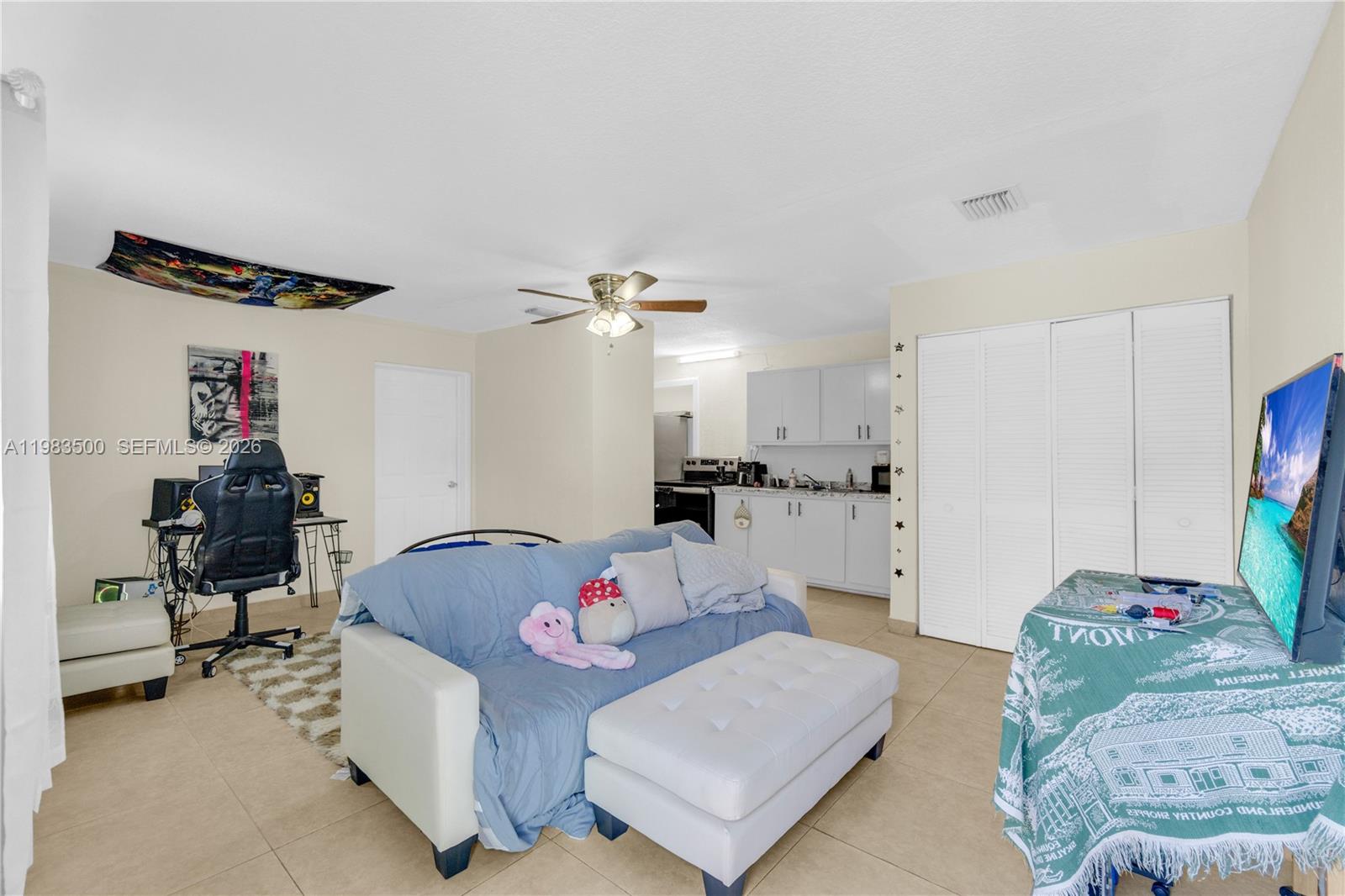 12691 Southwest 190th Street Miami, FL 33177 - Photo 32 of 46 a living room with furniture and a chandelier