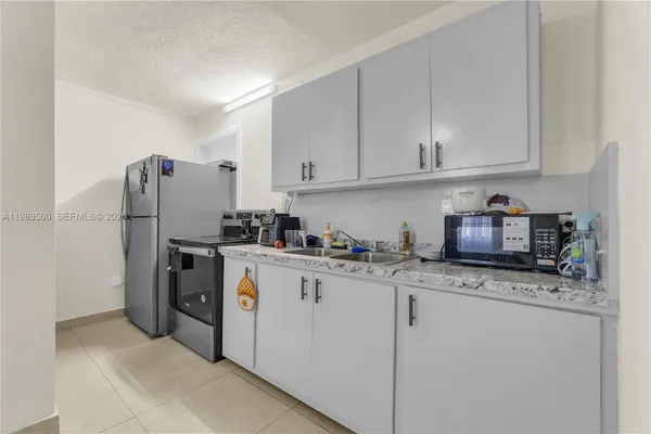 a kitchen with stainless steel appliances granite countertop a refrigerator sink and cabinets