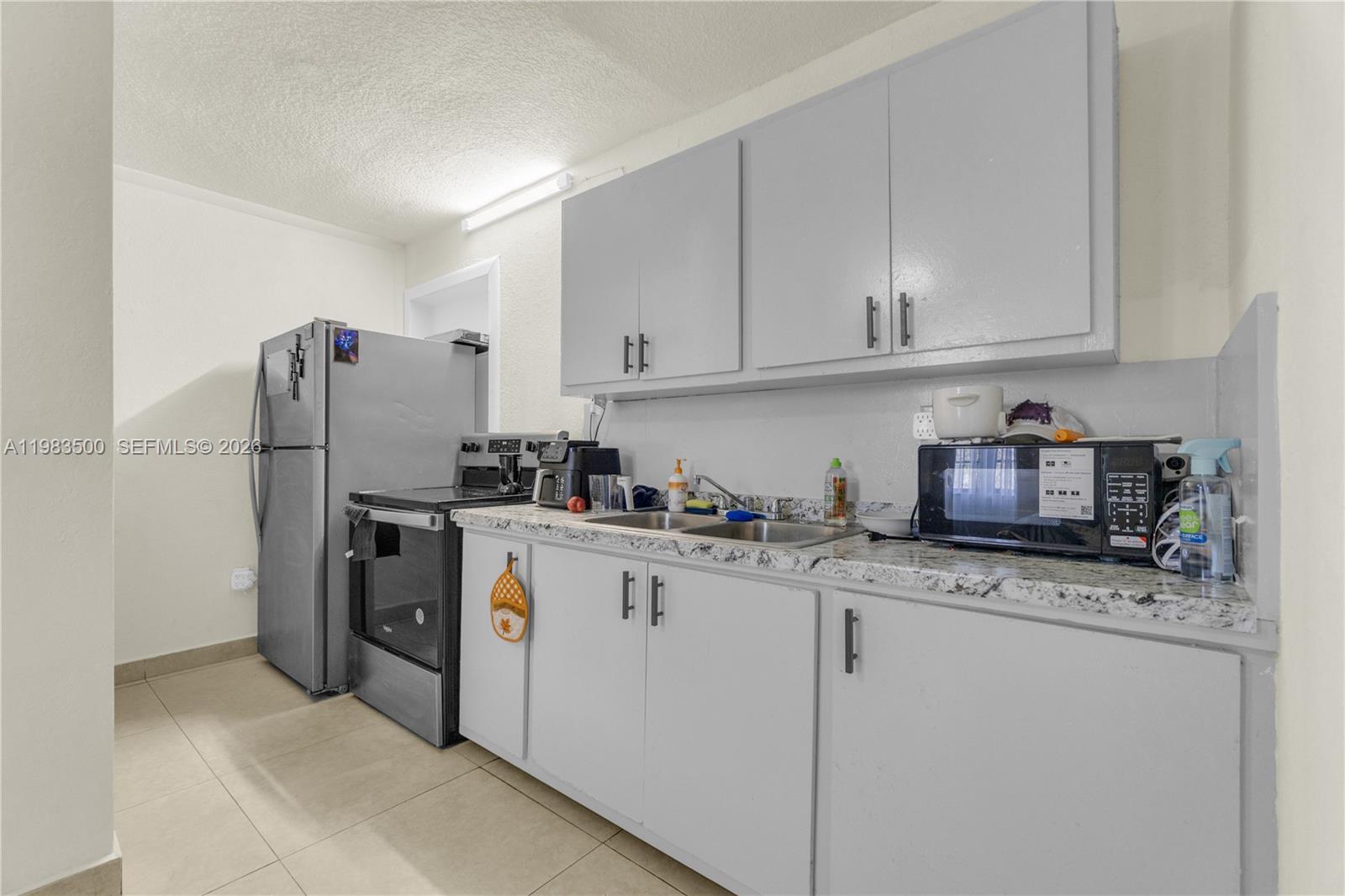 12691 Southwest 190th Street Miami, FL 33177 - Photo 33 of 46 a kitchen with stainless steel appliances granite countertop a refrigerator sink and cabinets