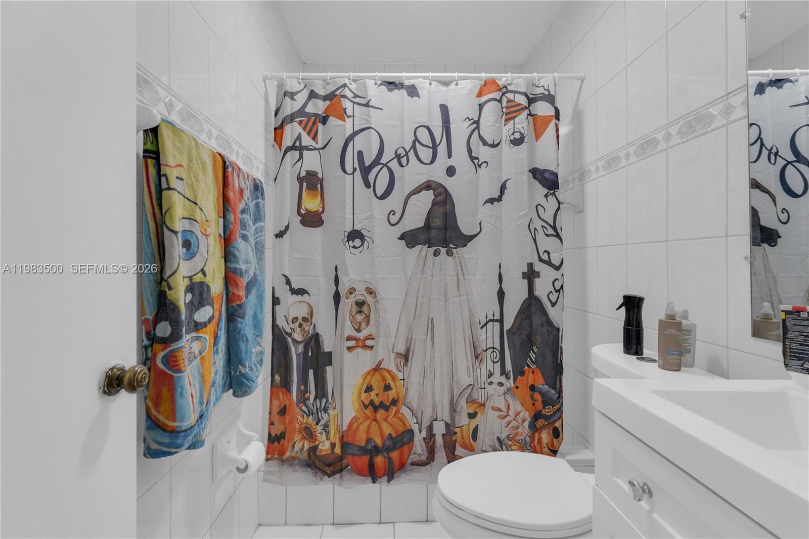 12691 Southwest 190th Street Miami, FL 33177 - Photo 35 of 46 a bathroom with a toilet and shower curtain