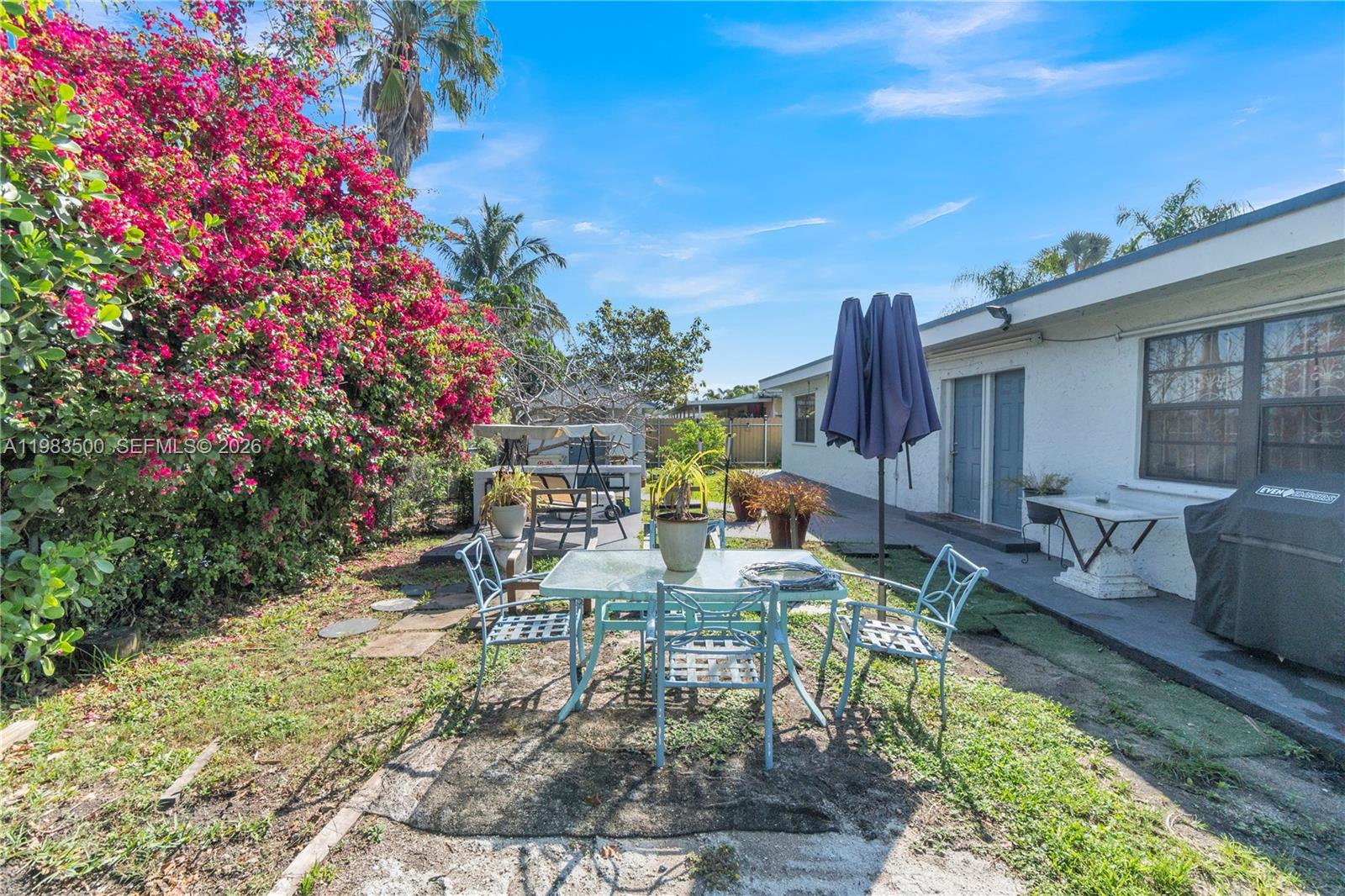 12691 Southwest 190th Street Miami, FL 33177 - Photo 39 of 46 a view of a patio with table and chairs and potted plants