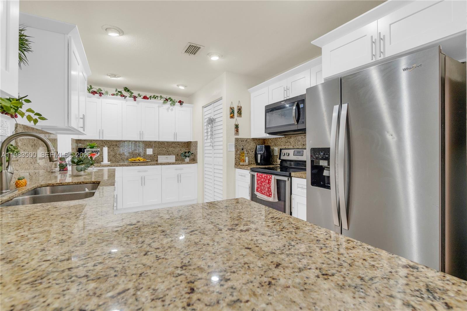 12691 Southwest 190th Street Miami, FL 33177 - Photo 5 of 46 a kitchen with stainless steel appliances kitchen island granite countertop a refrigerator and a sink