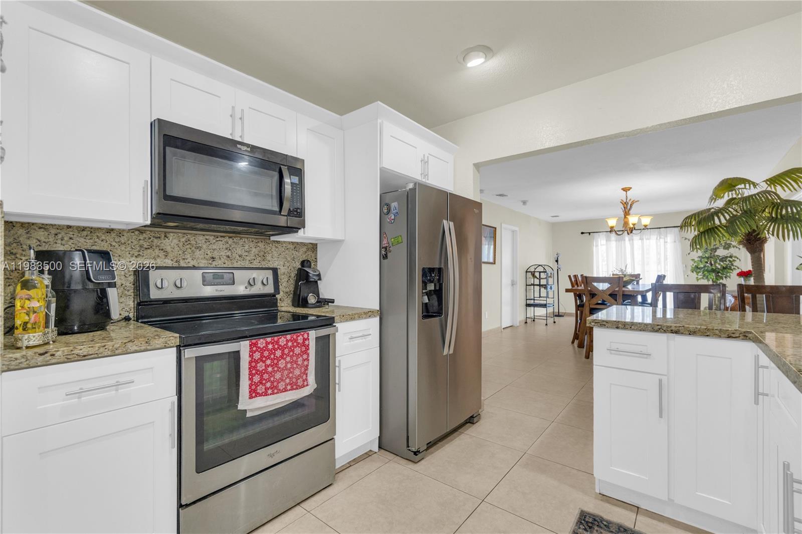 12691 Southwest 190th Street Miami, FL 33177 - Photo 7 of 46 a kitchen with stainless steel appliances granite countertop a refrigerator and a stove top oven