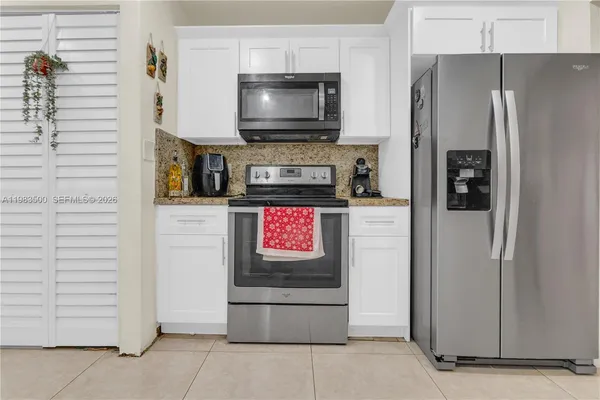 a kitchen with stainless steel appliances a refrigerator a stove and a microwave