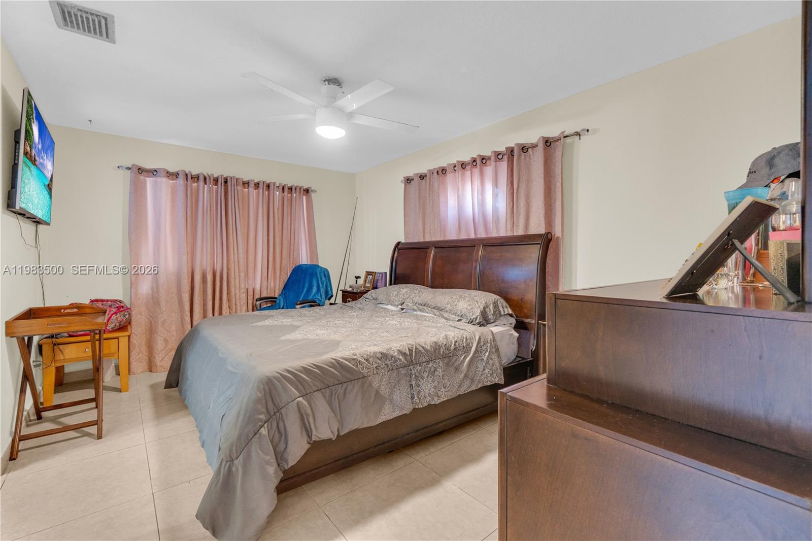 12691 Southwest 190th Street Miami, FL 33177 - Photo 9 of 46 a bedroom with a bed and chair