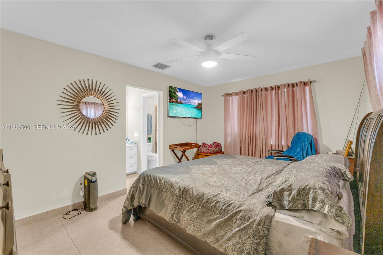 12691 Southwest 190th Street Miami, FL 33177 - Photo 10 of 46 a bedroom with a bed and a chandelier