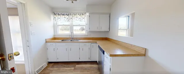 a room with a window a sink and a window