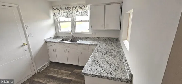a kitchen with sink and window