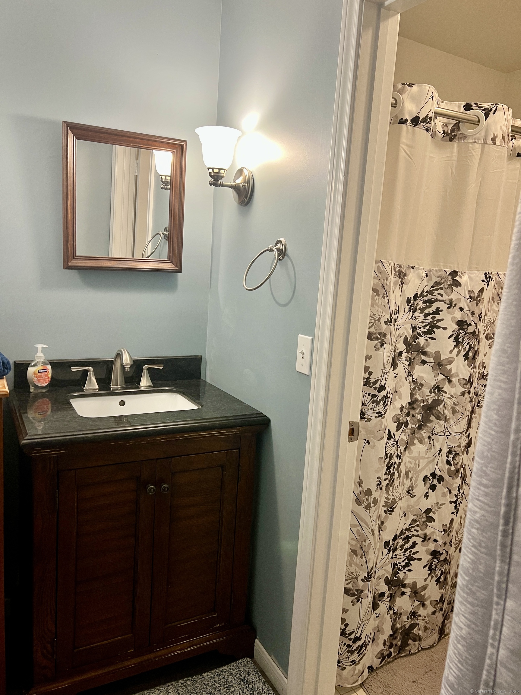 1623 Old Pond Lane, Unit 1623 Norwich, CT 06360 - Photo 13 of 40 a bathroom with a granite countertop sink and a mirror