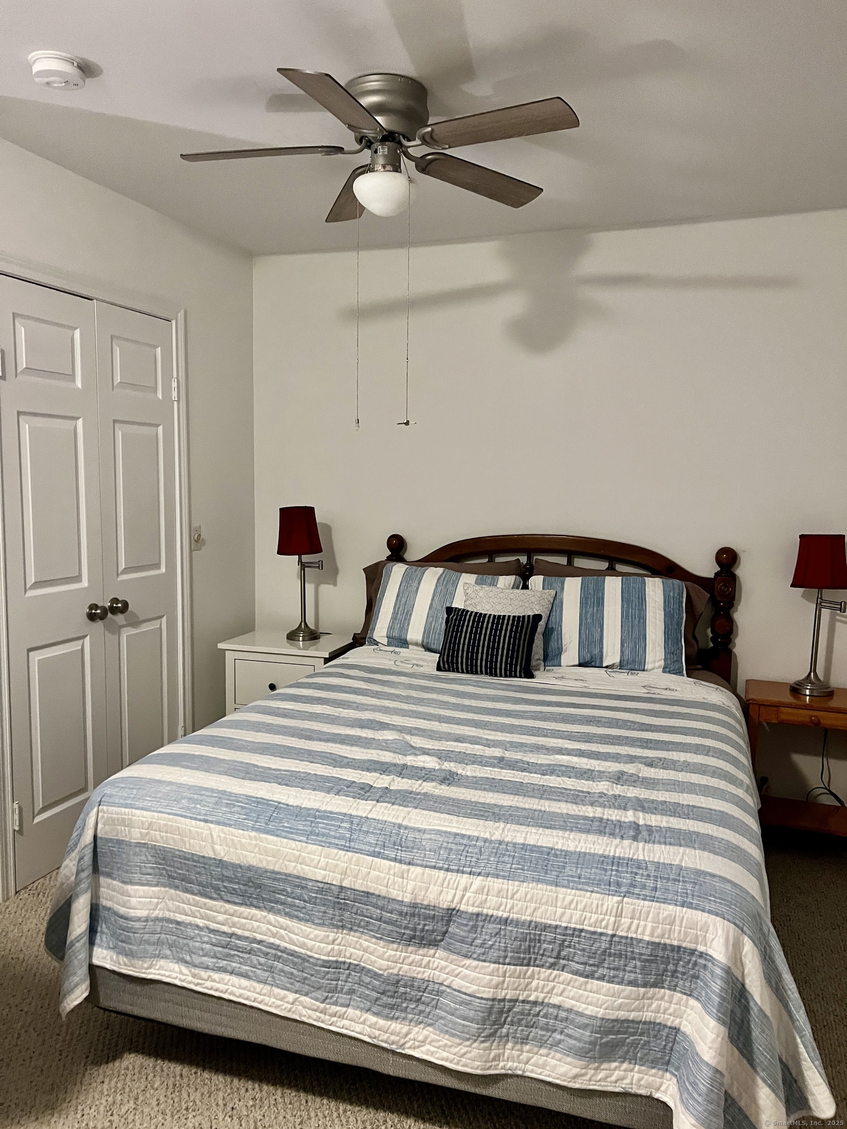 1623 Old Pond Lane, Unit 1623 Norwich, CT 06360 - Photo 17 of 40 a bedroom with a bed and a chandelier