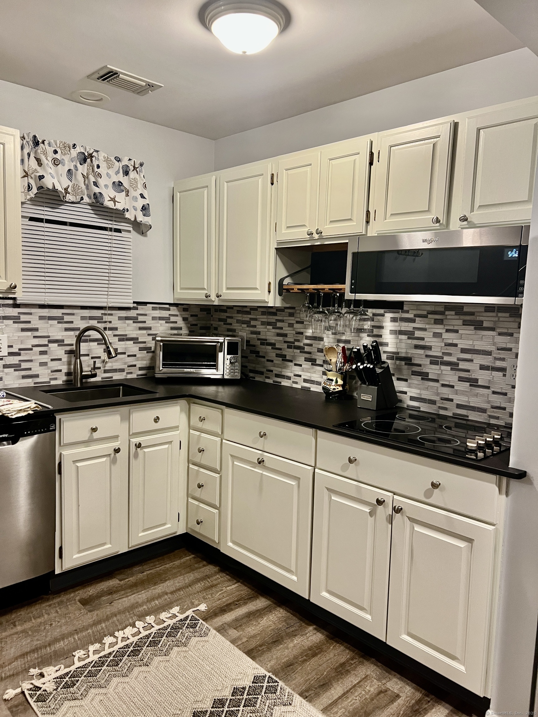 1623 Old Pond Lane, Unit 1623 Norwich, CT 06360 - Photo 3 of 40 a kitchen with stainless steel appliances granite countertop a stove a sink and white cabinets