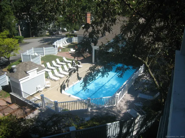 a front view of a house with glass windows and yard