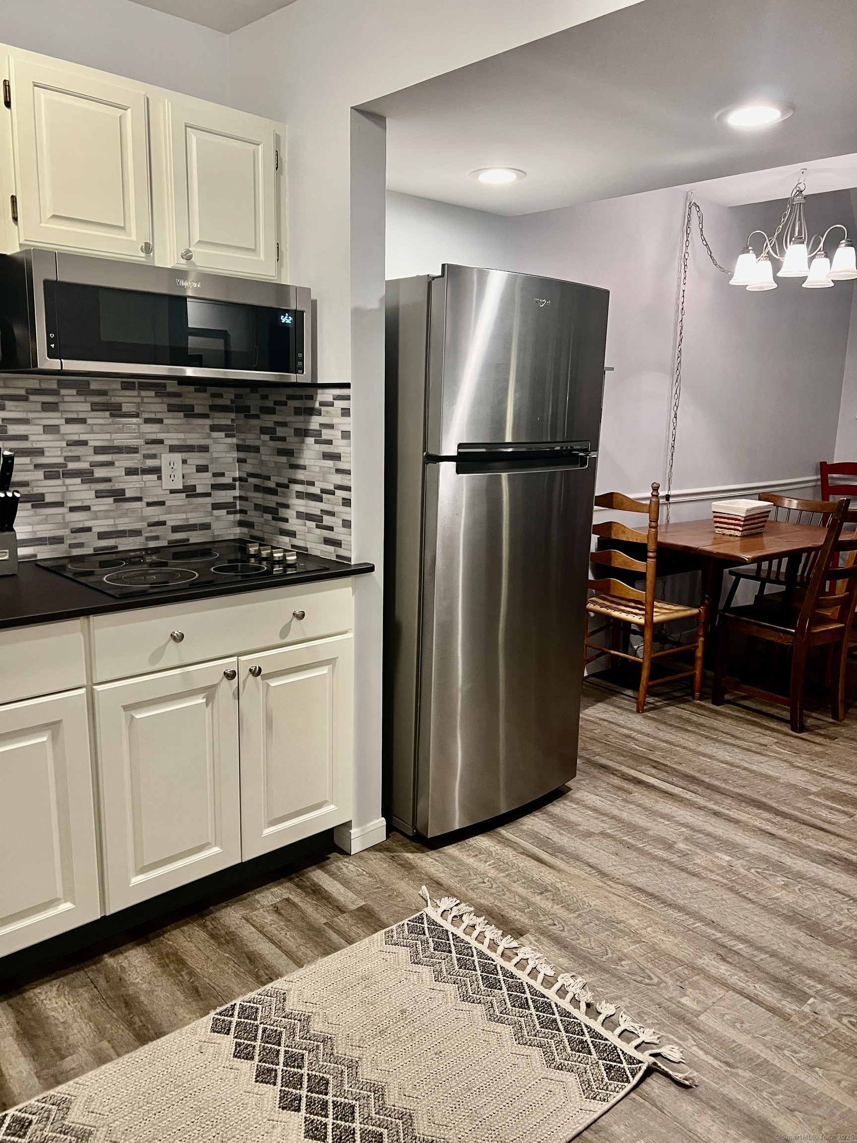 1623 Old Pond Lane, Unit 1623 Norwich, CT 06360 - Photo 5 of 40 a kitchen with stainless steel appliances granite countertop a refrigerator a stove and a sink with wooden cabinets