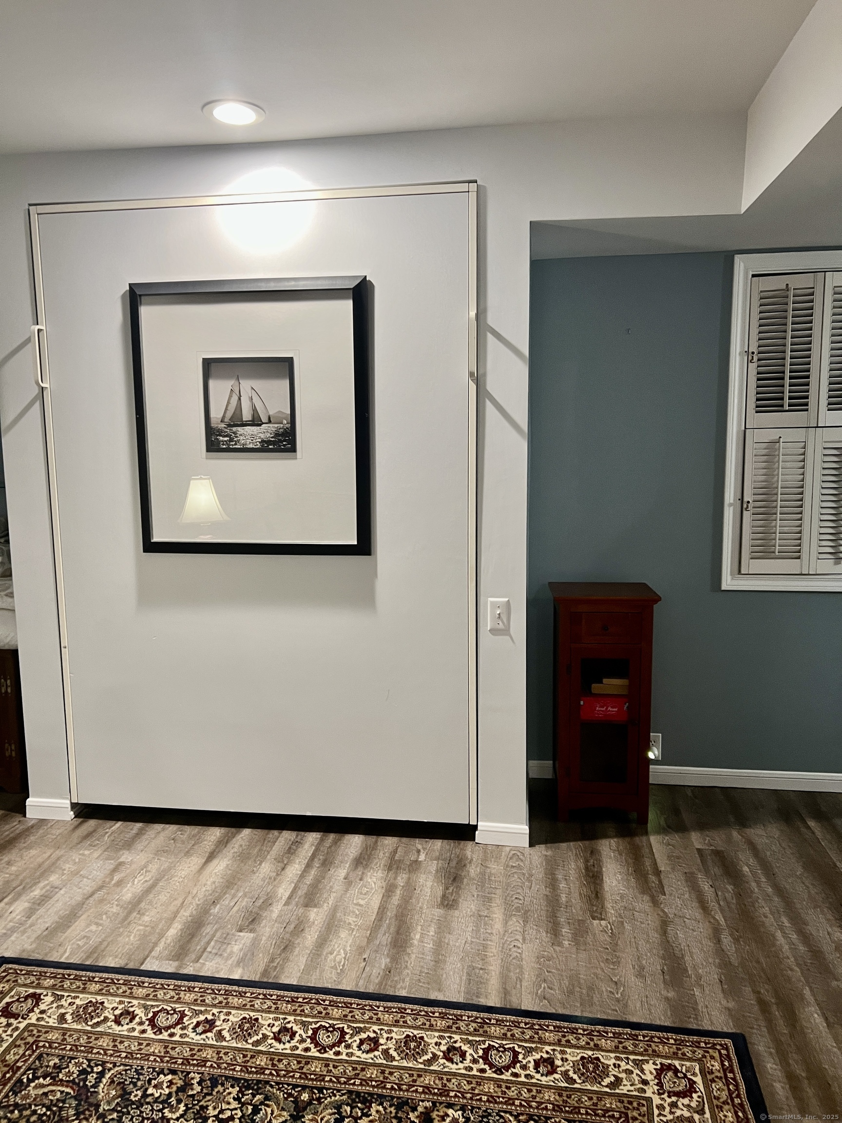 1623 Old Pond Lane, Unit 1623 Norwich, CT 06360 - Photo 9 of 40 a view of a hallway with wooden floor and a bookshelf
