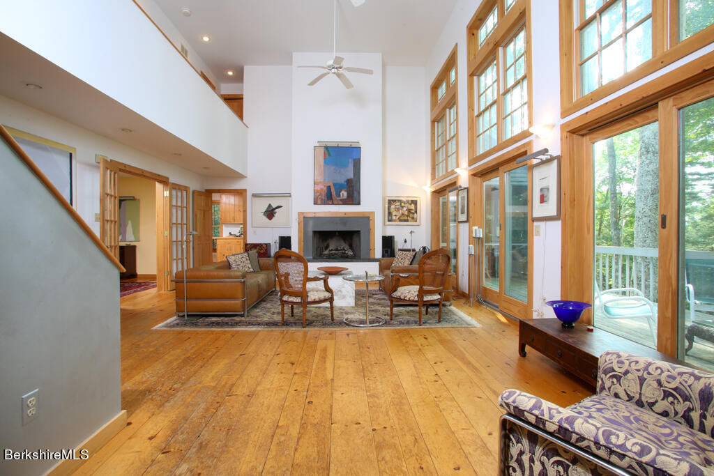 142 Main Road Monterey, MA 01230 - Photo 1 of 32 a living room with fireplace furniture and a large window